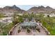 Aerial shot of community entrance with meticulously maintained landscaping and mature trees at 3120 E Squaw Peak Cir, Phoenix, AZ 85016