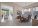 Dining room featuring dark wood table, decorative chandelier and sliding glass door at 3120 E Squaw Peak Cir, Phoenix, AZ 85016