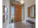 Bright entryway with tile floors, wood door and bench at 3120 E Squaw Peak Cir, Phoenix, AZ 85016