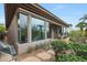 Beautiful home exterior featuring large windows and a well-manicured backyard at 3120 E Squaw Peak Cir, Phoenix, AZ 85016