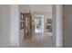 Hallway with tile flooring, an antique display case, and an open view into the living and dining areas at 3120 E Squaw Peak Cir, Phoenix, AZ 85016