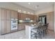 Bright kitchen with wood cabinets, granite countertops, a large kitchen island, and stainless steel appliances at 3120 E Squaw Peak Cir, Phoenix, AZ 85016