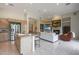 Open concept living room with kitchen island, fireplace, and built-in shelving for seamless living and entertaining at 3120 E Squaw Peak Cir, Phoenix, AZ 85016
