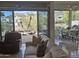 Bright living room featuring comfortable seating, tile floors, and a scenic view of the backyard and mountains at 3120 E Squaw Peak Cir, Phoenix, AZ 85016