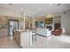 Open-concept living space with a kitchen island, stainless steel appliances, fireplace and comfortable seating at 3120 E Squaw Peak Cir, Phoenix, AZ 85016