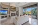 Cozy living room featuring a fireplace, built-in shelving, and access to the backyard at 3120 E Squaw Peak Cir, Phoenix, AZ 85016