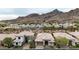 Home's aerial view boasts desert landscape and nearby mountain view at 3120 E Squaw Peak Cir, Phoenix, AZ 85016