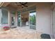 Covered patio featuring stone flooring, ceiling fan, and sliding glass doors offering seamless indoor-outdoor living at 3120 E Squaw Peak Cir, Phoenix, AZ 85016
