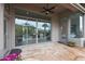 Covered patio with stone flooring and glass doors offer seamless indoor-outdoor living at 3120 E Squaw Peak Cir, Phoenix, AZ 85016