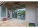 Covered patio featuring stone flooring, ceiling fan, and sliding glass doors offering seamless indoor-outdoor living at 3120 E Squaw Peak Cir, Phoenix, AZ 85016