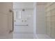 Well-lit shower with white tile, glass block accent window, and grab bars at 3120 E Squaw Peak Cir, Phoenix, AZ 85016