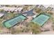 Aerial view of well-maintained tennis courts with desert landscape and nearby parking at 3120 E Squaw Peak Cir, Phoenix, AZ 85016
