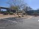 A view of the community tennis courts with mature trees and desert landscaping from the parking area at 3120 E Squaw Peak Cir, Phoenix, AZ 85016