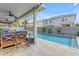 Relaxing backyard features a refreshing in-ground pool and covered patio with comfortable seating at 3555 E Gary Way, Gilbert, AZ 85234