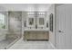 Bathroom with walk-in shower, double sinks, framed mirrors, and modern neutral decor at 3555 E Gary Way, Gilbert, AZ 85234