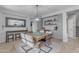 Dining area with wooden table, a decorative mirror, a built-in bar, and view into the house at 3555 E Gary Way, Gilbert, AZ 85234