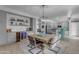 Spacious dining area with a large wooden table, stylish seating, and a built-in bar with wine cooler at 3555 E Gary Way, Gilbert, AZ 85234