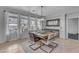 Elegant dining area with modern light fixture, large windows, and cozy seating for six at 3555 E Gary Way, Gilbert, AZ 85234