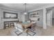 Dining room with a solid wood table, elegant chairs, and a built-in bar area with shelving and cabinets at 3555 E Gary Way, Gilbert, AZ 85234