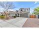 Neutral color scheme two-story home with a driveway, beautiful landscaping, and a two-car garage at 3555 E Gary Way, Gilbert, AZ 85234