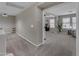 Hallway view with carpet flooring leading to another room with natural light, a dresser and plant at 3555 E Gary Way, Gilbert, AZ 85234