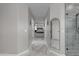 Hallway view to the main bedroom, showing neutral decor and modern upgrades, including a walk-in shower at 3555 E Gary Way, Gilbert, AZ 85234