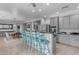 Open-concept kitchen featuring a breakfast bar with seating and stainless steel appliances at 3555 E Gary Way, Gilbert, AZ 85234