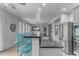 Beautiful kitchen island with bar seating, granite countertops, and stainless steel refrigerator at 3555 E Gary Way, Gilbert, AZ 85234