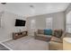 Cozy living room with a comfortable sectional sofa, a TV and lots of natural light at 3555 E Gary Way, Gilbert, AZ 85234