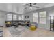 Comfortable living room features a large sectional, tile floors, neutral tones and large bright windows at 3555 E Gary Way, Gilbert, AZ 85234
