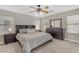 Bright main bedroom featuring plush carpet, ceiling fan, and dresser with mirror at 3555 E Gary Way, Gilbert, AZ 85234