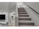 Carpeted staircase with a dark handrail, leading to the upper level of the home at 3555 E Gary Way, Gilbert, AZ 85234