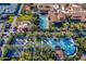 Aerial view of the community resort, pool, tennis courts, manicured grounds, and beautiful Southwestern-style buildings at 37036 N Stoneware Dr, Queen Creek, AZ 85140