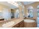 An elegant primary bathroom boasts a soaking tub and a connecting bedroom view at 37036 N Stoneware Dr, Queen Creek, AZ 85140