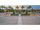 Community clubhouse entrance featuring lush landscaping, palms, and a beautiful water fountain at 37036 N Stoneware Dr, Queen Creek, AZ 85140