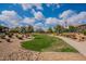 Lush community park with walking paths, green space, and mature trees, ideal for outdoor recreation at 37036 N Stoneware Dr, Queen Creek, AZ 85140