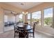 Bright breakfast nook features sliding glass doors and large windows overlooking the landscaped backyard at 37036 N Stoneware Dr, Queen Creek, AZ 85140