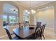 Formal dining room with elegant chandelier, archways to living spaces and a neutral color palette at 37036 N Stoneware Dr, Queen Creek, AZ 85140
