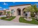 Charming front exterior with stucco, well-manicured landscaping, and a welcoming covered entrance at 37036 N Stoneware Dr, Queen Creek, AZ 85140
