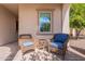 Cozy front porch with seating and a small table, creating a welcoming entrance to the home at 37036 N Stoneware Dr, Queen Creek, AZ 85140