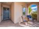 Inviting front porch with comfortable seating, offering a relaxing spot to enjoy the neighborhood views at 37036 N Stoneware Dr, Queen Creek, AZ 85140