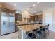 Gourmet kitchen featuring stainless steel appliances, custom cabinetry, granite countertops, and a large island at 37036 N Stoneware Dr, Queen Creek, AZ 85140