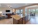 Open-concept kitchen with a large island, bar seating, and views to the dining and living areas at 37036 N Stoneware Dr, Queen Creek, AZ 85140