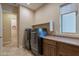The laundry area features updated appliances and lots of counter space at 37036 N Stoneware Dr, Queen Creek, AZ 85140