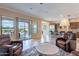 Open-concept living area with sliding glass doors leading to the patio and a view into the modern kitchen at 37036 N Stoneware Dr, Queen Creek, AZ 85140