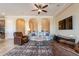 Bright and airy living room with archways, comfortable seating, a ceiling fan, and a decorative rug at 37036 N Stoneware Dr, Queen Creek, AZ 85140