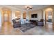 Spacious living room with neutral tones, recessed lighting, and arched doorways for an open, airy feel at 37036 N Stoneware Dr, Queen Creek, AZ 85140