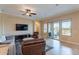 Spacious living room featuring tile flooring, a ceiling fan, and sliding glass doors to the outdoor patio at 37036 N Stoneware Dr, Queen Creek, AZ 85140