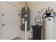 A utility room is equipped with a water heater and filtration system at 37036 N Stoneware Dr, Queen Creek, AZ 85140