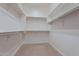 Spacious walk-in closet with carpeted flooring and plenty of shelving at 37036 N Stoneware Dr, Queen Creek, AZ 85140